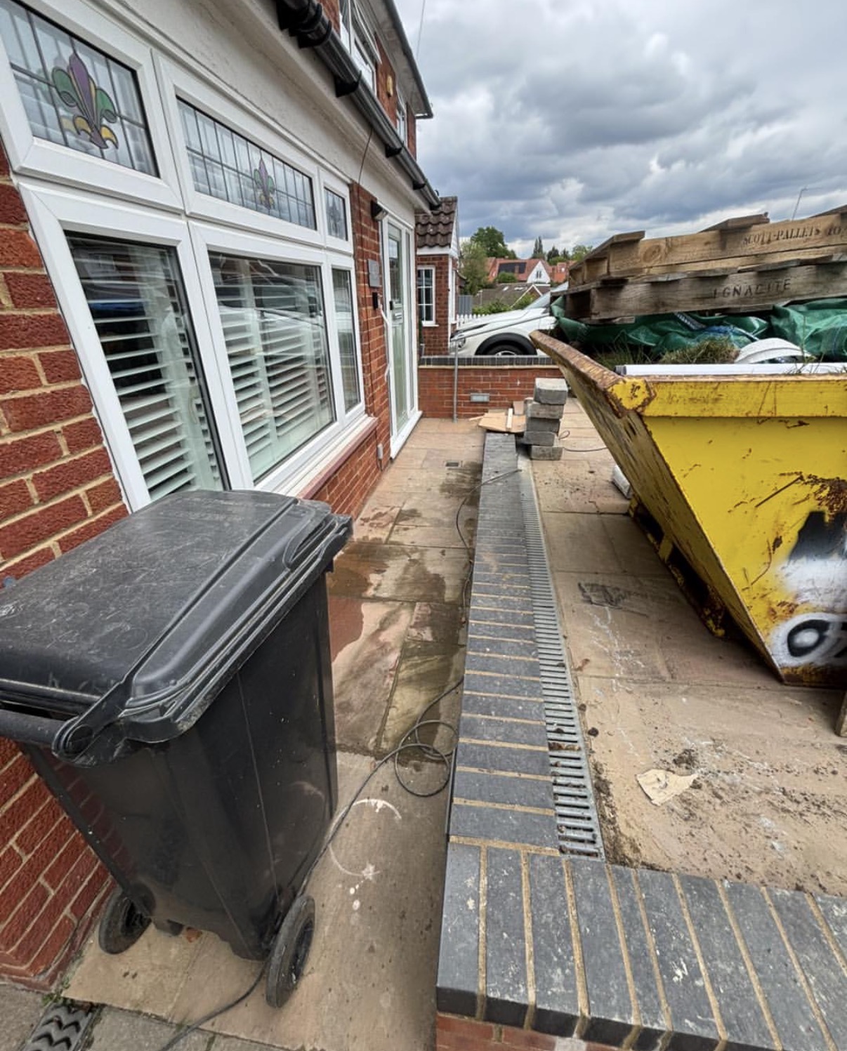 Skip alternative same day clearance beside driveway