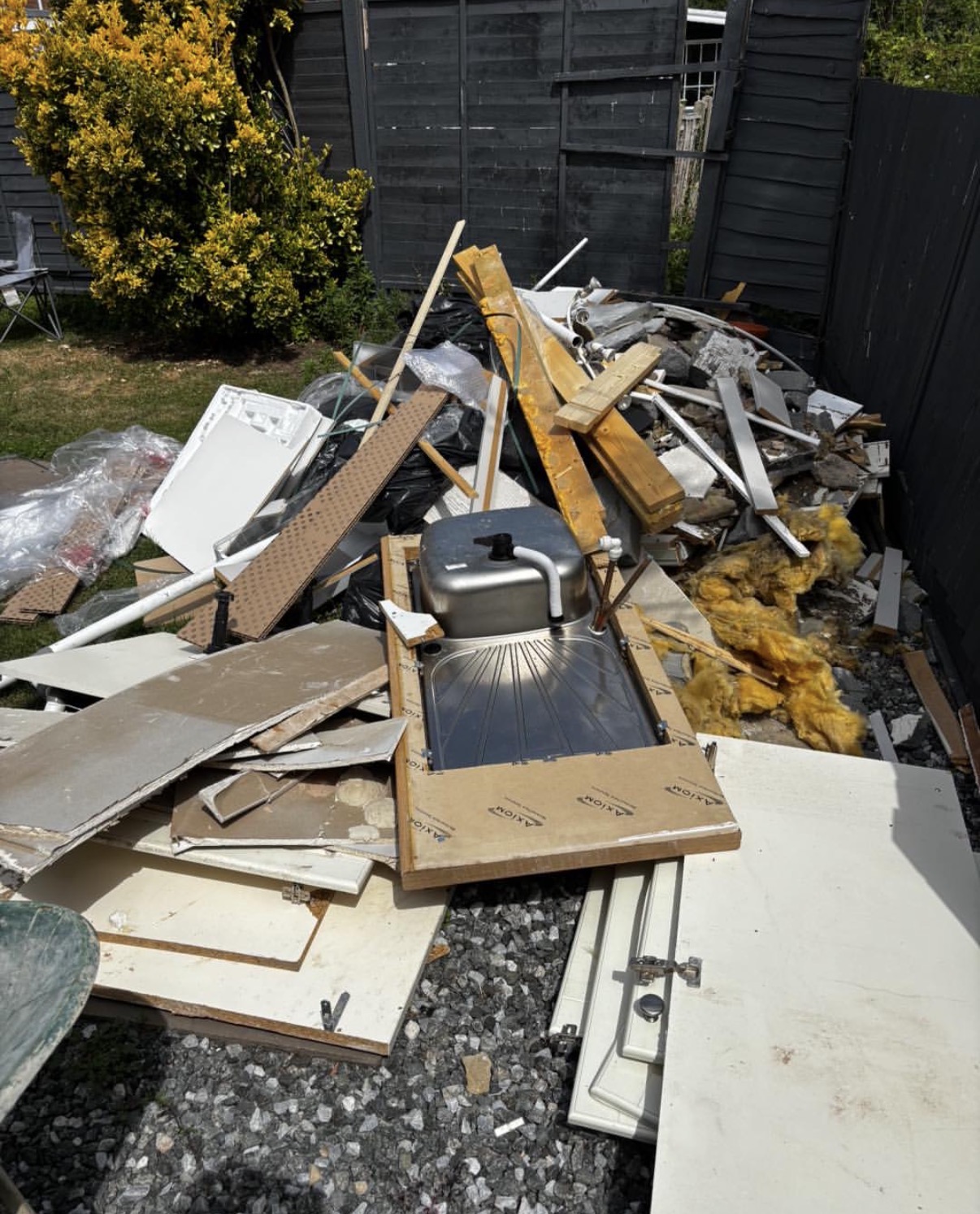 Kitchen rip-out and bathroom waste piled in rear garden